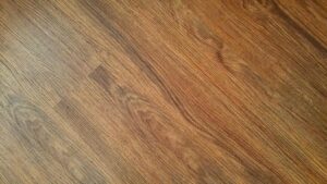 Detailed image of rustic wooden flooring with visible wood grain texture.