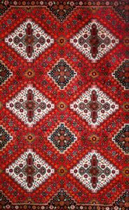 Detailed traditional oriental carpet pattern with vibrant colors and geometric motifs.